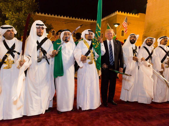 President Trump stands surrounded by ceremonial swordsmen during his visit to Saudi Arabia in 2017.